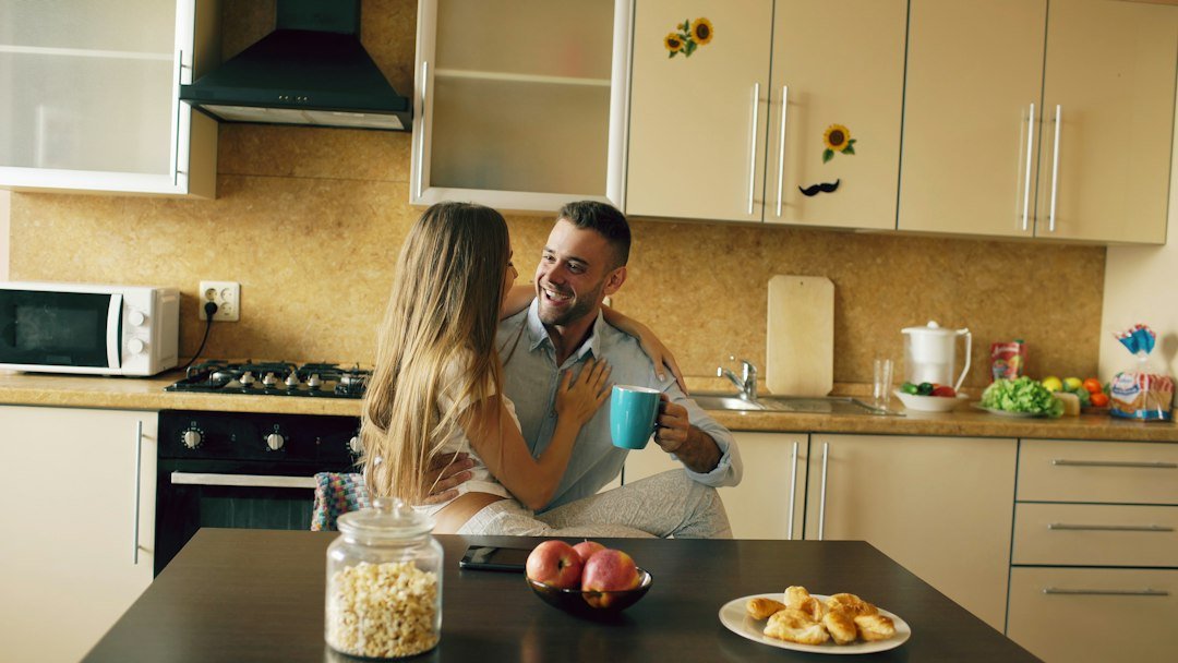 Couple enjoying coffee in a bright kitchen setting