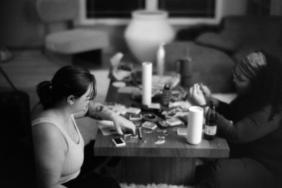 Two people playing a game at a coffee table